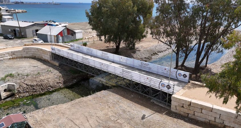 Aerial view of the scaffolding bridge across the Garyllis River in Limassol, with the coast behind it